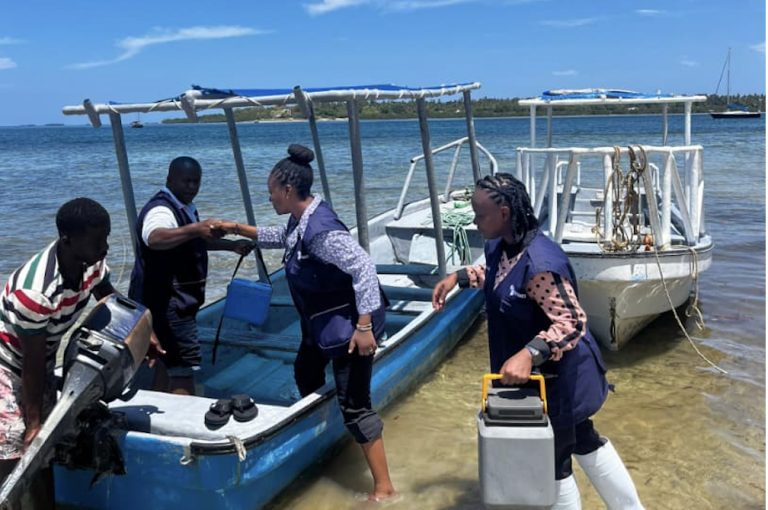 TFELTP residents, in collaboration with the Regional Immunization and Vaccination Officer (RIVO) for Pwani Region, supporting vaccine transportation to nearby